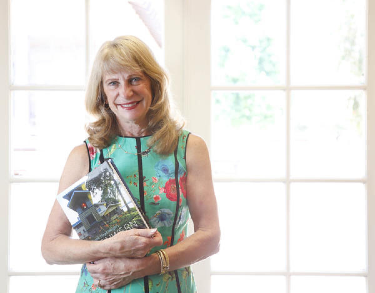 Sue Major, photographed at her office in Rancho Santa Fe, holds a copy of the new book she and her husband, John, co-commissioned, "Frank Lloyd Wright's Penwern: A Summer Estate." The Majors have spent the past 25 years restoring the Wisconsin lake house to Wright's original drawn plans.