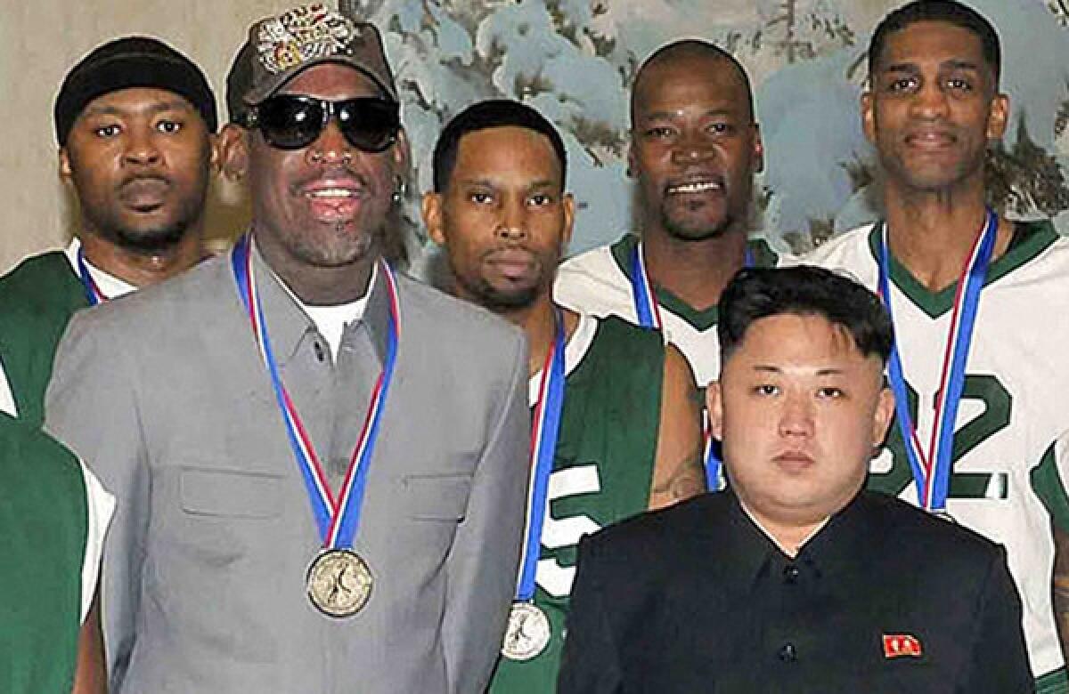 Retired NBA star Dennis Rodman, left, and former NBA players pose with North Korean leader Kim Jong Un at a gymnasium in Pyongyang on Wednesday.