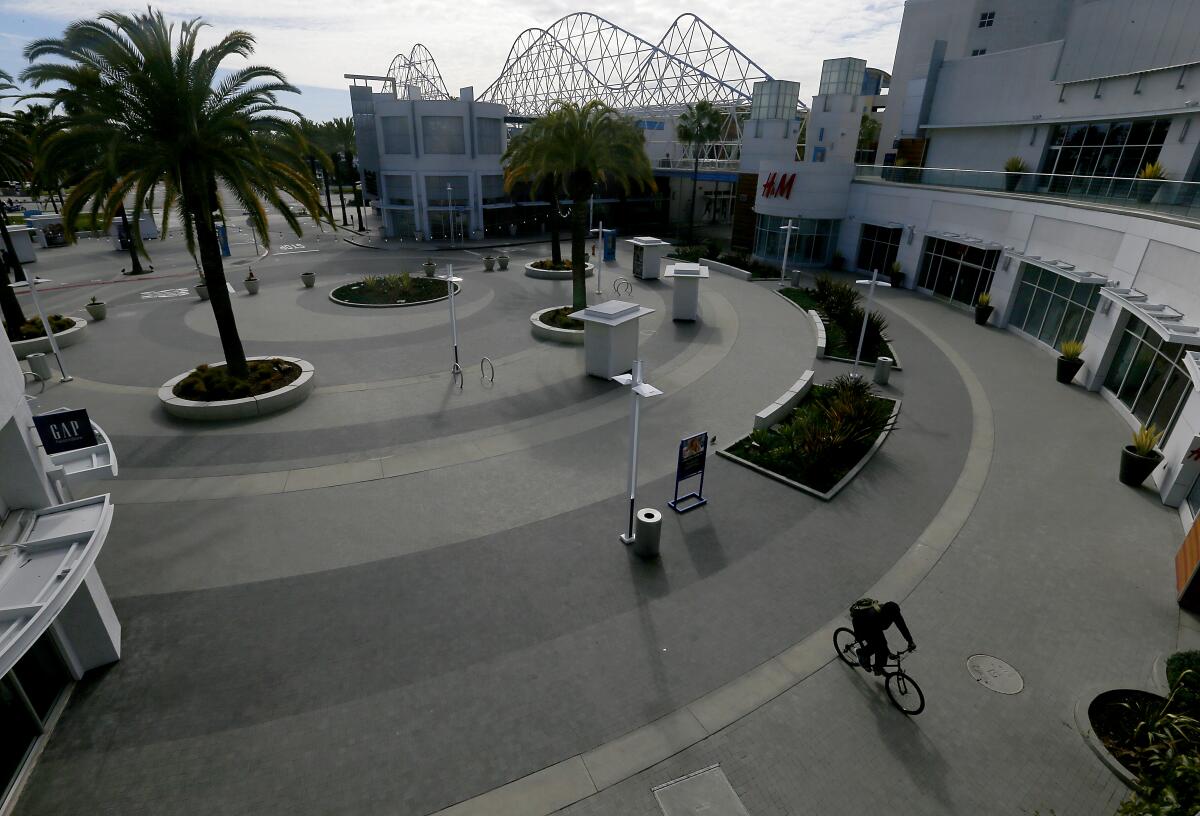 The Pike in Long Beach -- normally crowded with weekend shoppers, diners and moviegoers -- is almost completely deserted on Saturday, March 21.