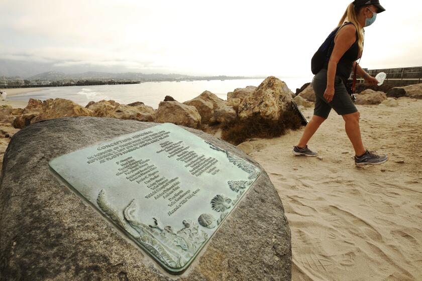 SANTA BARBARA , CA - SEPTEMBER 02: Susan Tibbles walks past a memorial for the 34 people who died in the Conception Boat fire one year ago today after family members with friends and officials gathered at Point Castillo at the end of Harbor Walk in the Santa Barbara Harbor where a plaque on a boulder was unveiled to memorialize the 34 lives lost in the Conception Diving Boat fire off Santa Cruz Island on the one year anniversary. Santa Barbara Harbor on Wednesday, Sept. 2, 2020 in Santa Barbara , CA. (Al Seib / Los Angeles Times