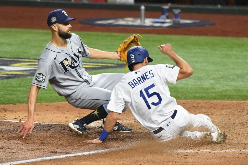ARLINGTON, TEXAS OCTOBER 27, 2020-Dodgers Austin Barnes scores in front of Rays pitcher Nick Anderson on a wild pitch in the 6t inning in Game 6 of the World Series at Globe Life Field in Arlington, Texas Tuesday. (Wally Skalij/Los Angeles Times)