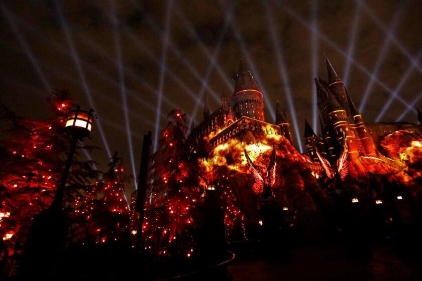 UNIVERSAL CITY, CA - MAY 16, 2017 - The Nighttime Lights at Hogwarts TM Castle Gryffindor House imagery is projected against Hogwarts Castle against a web of spot lights as part of the new light show for, "The Wizarding World of Harry Potter," at Universal Studios on May 16, 2017. The addition to the site is a colorful state-of-the-art light display and special effects projection accompanied by an original arrangement overseen by Academy-Award winning composer John Williams. (Genaro Molina/Los Angeles Times) Photo Embargoed until Thursday, May 18, 2017, 6 a.m.