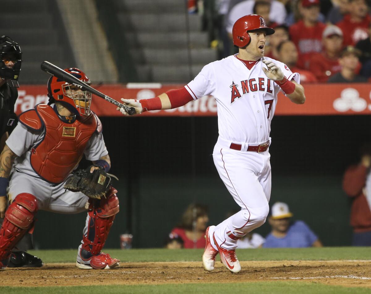 Angels infielder Cliff Pennington drives in a run with a base hit during the fourth inning of a game against the Cardinals on May 12.