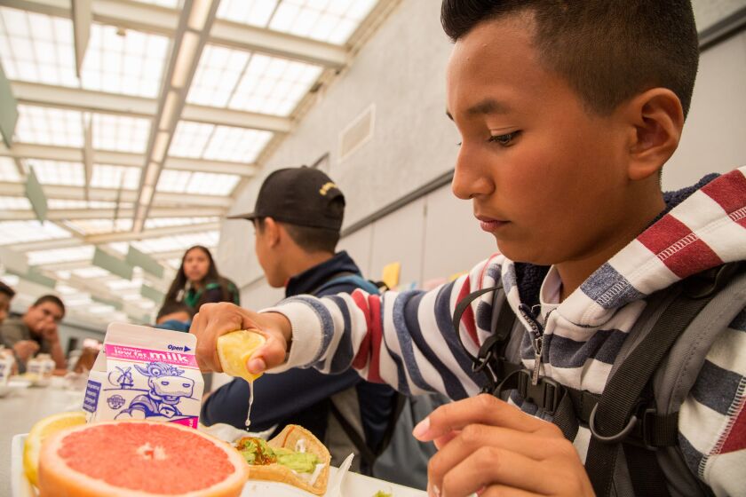 8th grader, Oscar Peña, squeezes lemon onto a grilled fish taco during California Thursdays," at San Ysidro Middle School. March, 17 2016. Photo by David Hodges.