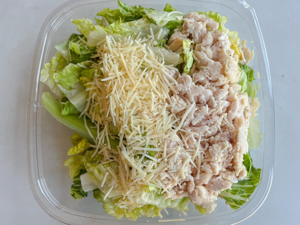 The rotisserie chicken Caesar salad in a plastic container at Costco