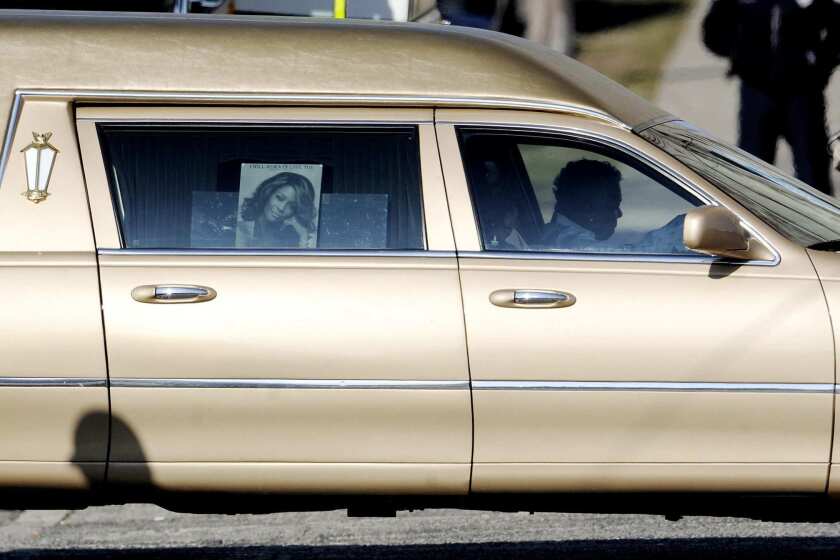 The hearse that carrying the body of singer Whitney Houston drives past the New Hope Baptist Church before Houston's funeral in Newark, N.J. Houston died Feb. 11 in Beverly Hills, where she had planned to attend a pre-Grammys event. FULL COVERAGE: Whitney Houston | 1963-2012