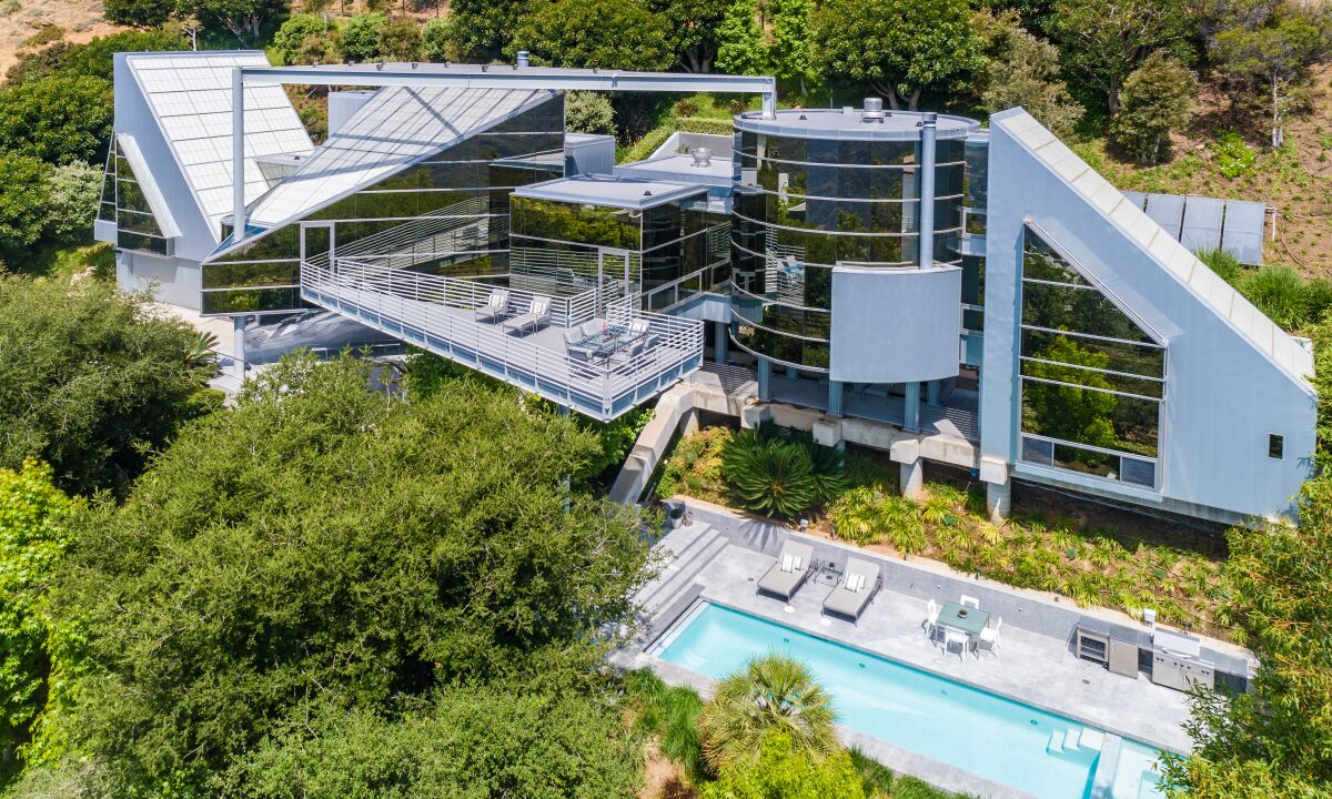 Built in 1998, the two-story home resembles a power plant with its jagged edges, glass turrets and industrial vibes.