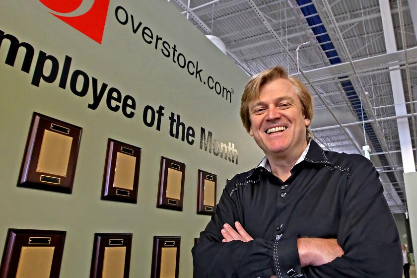 Chairman and CEO of OverStock.com Patrick M. Byrne poses for a picture by the employee of the month wall at the warehouse of Overstock.com just outside Salt Lake City, Utah on March 25, 2010. (AP Photo/George Frey)