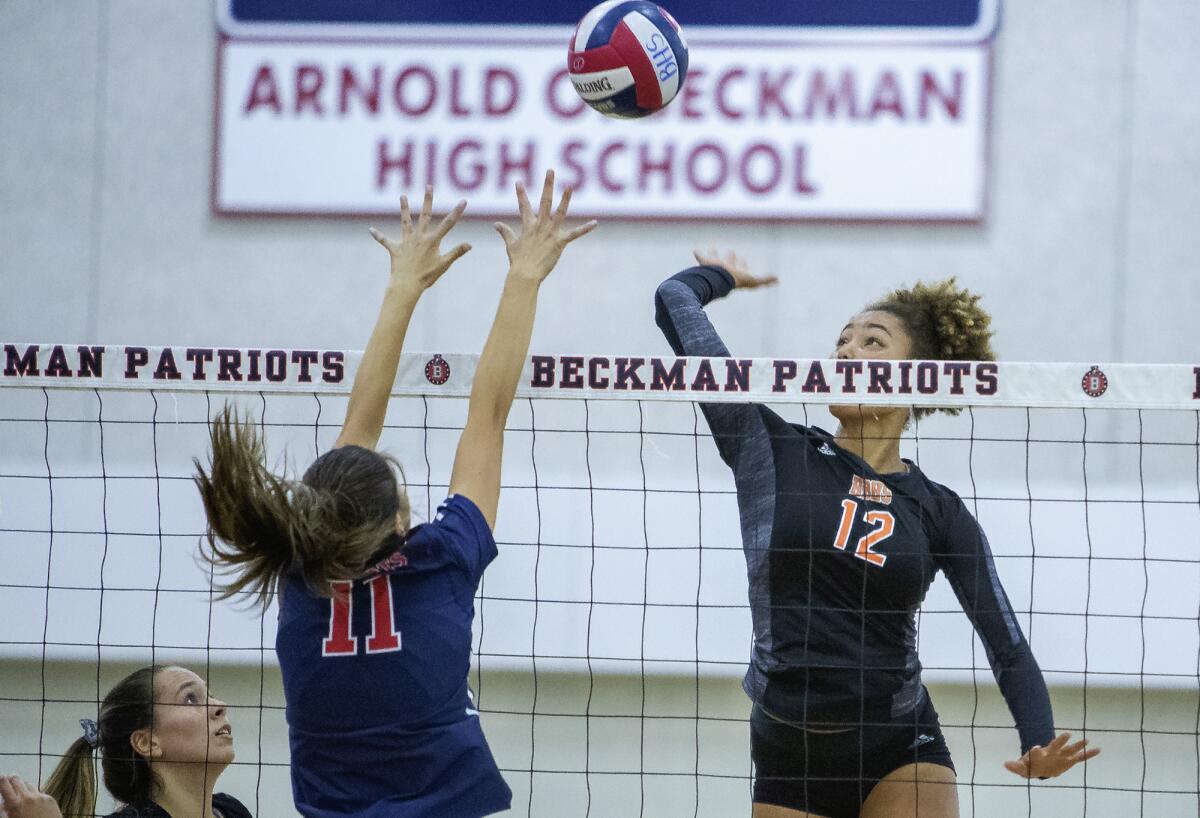 Huntington Beach's Xolani Hodel, right, shown hitting against Beckman's Caroline Llamas on Aug. 28, led the Oilers to a 25-19, 25-18, 26-24 win over Los Alamitos on Tuesday.