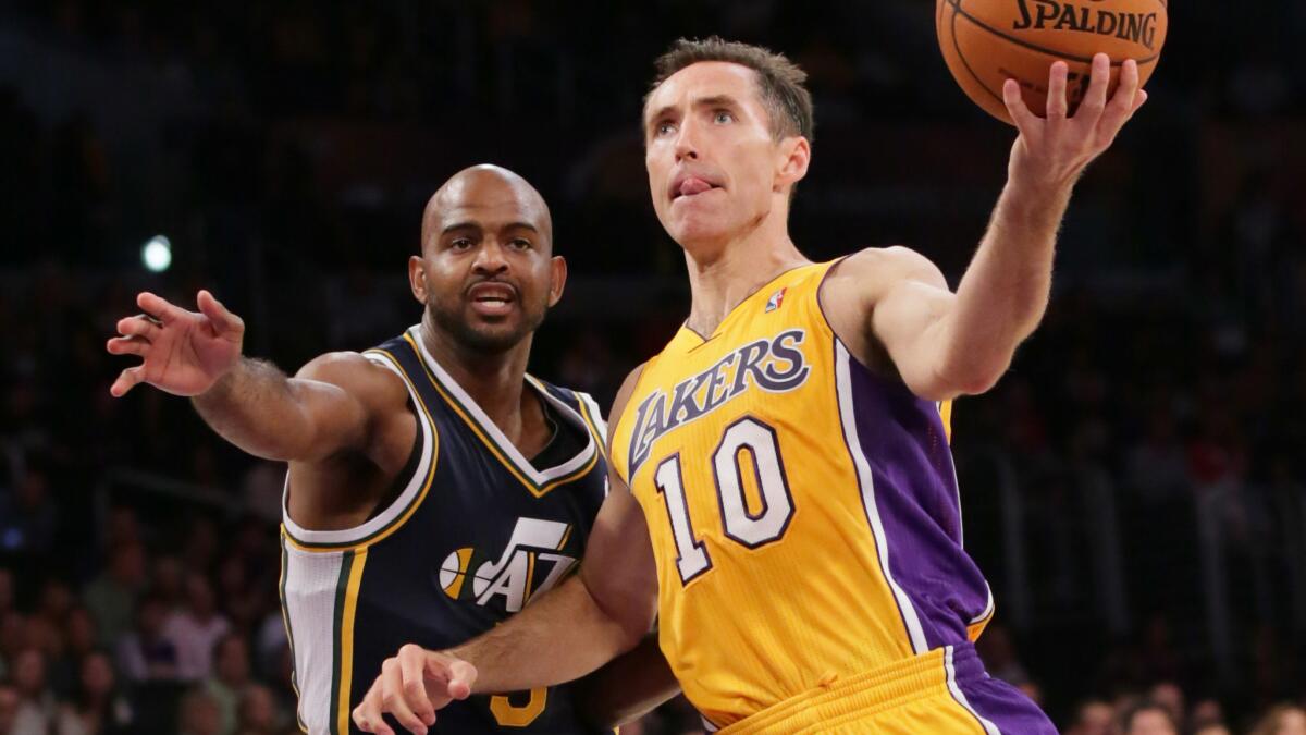 Lakers guard Steve Nash (10) drives past Utah's John Lucas III during a game at Staples Center in October 2013.