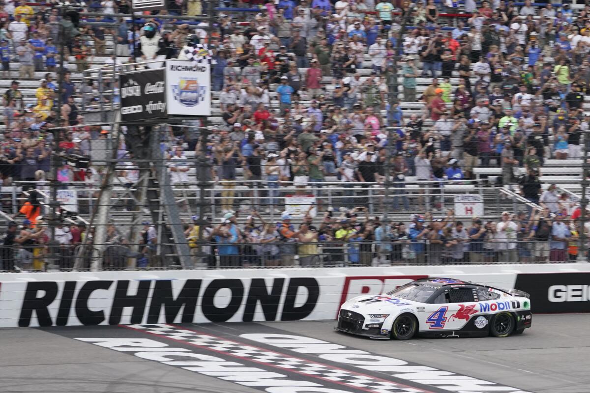 Kevin Harvick (4) crosses the finish line to win a NASCAR Cup Series auto race at Richmond Raceway, Sunday, Aug. 14, 2022, in Richmond, Va. (AP Photo/Steve Helber)