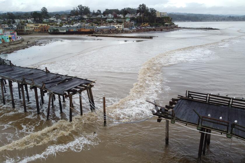 CAPITOLA, CALIFORNIA, UNITED STATES - 2023/01/16: (EDITOR'S NOTE: Image taken by a drone) A wharf in Capitola was broke during the storm. Powerful storm systems have slammed California since December 2022, with thousands of people impacted due to power outages, road closures, downed trees, landslide and flooding. The storm already caused at least twenty deaths in California with many injured. Joe Biden declared a state of emergency in California due to the storm. The president will visit the devastated areas of California on January 19. (Photo by Michael Ho Wai Lee/SOPA Images/LightRocket via Getty Images)