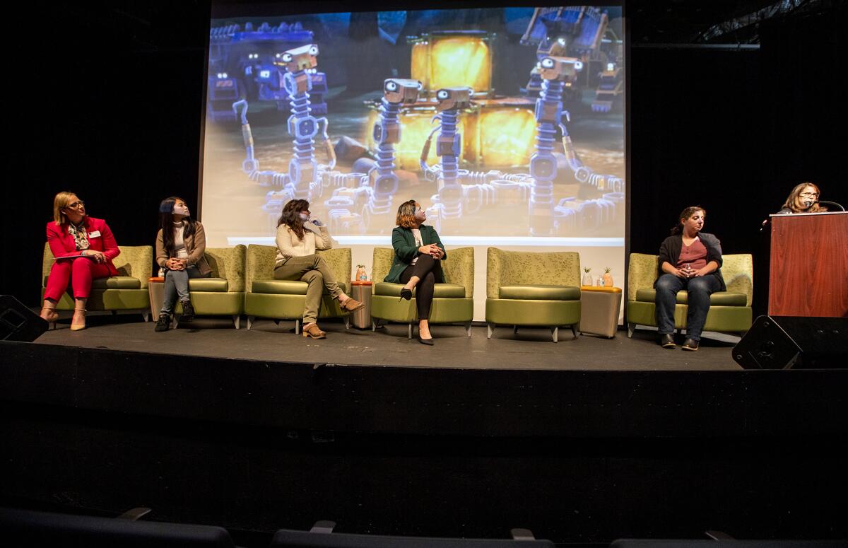 Natalie Moser, Belinda Ho, Elizabeth Steele Basile, Andrea Marr and Jennifer Kumar listen to Lisa Anderson.