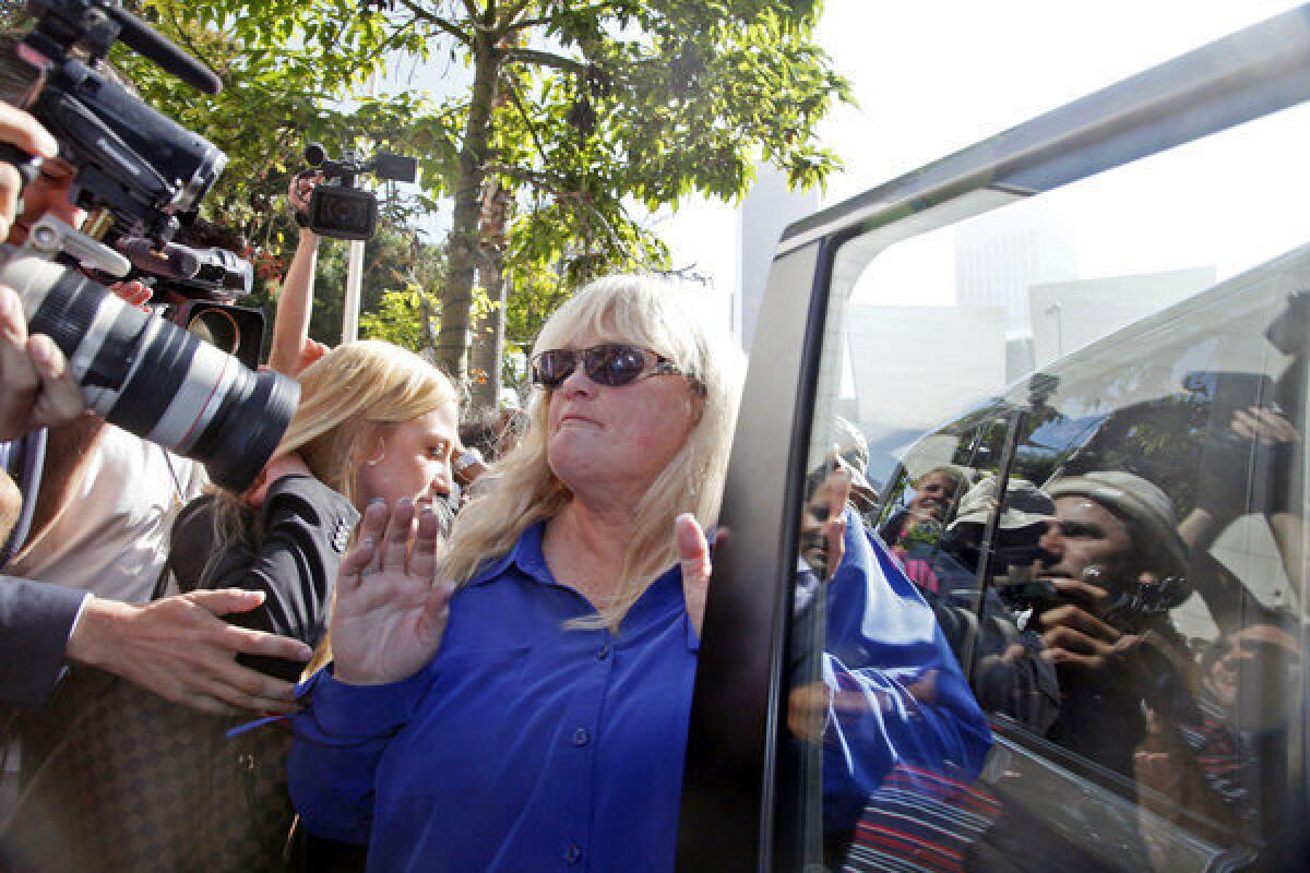 Debbie Rowe, Michael Jackson's ex-wife and mother of two of his children, leaves Los Angeles County Superior Court after testifying Wednesday in the wrongful death suit filed against AEG Live.