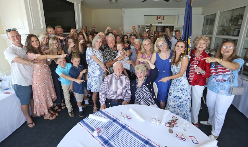 Joseph King, sitting with girlfriend Shirley, pause for group picture with extended family during his 100th birthday party.
