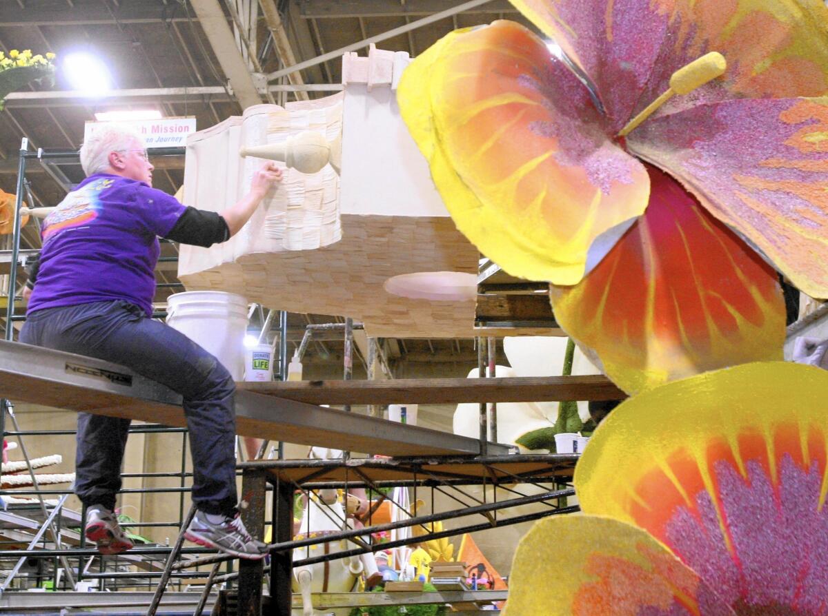 Beverly Meyer of Kansas City works on the Glendale float at Phoenix Decorating in Pasadena on Wednesday. The float is being built by volunteers from all over the nation.