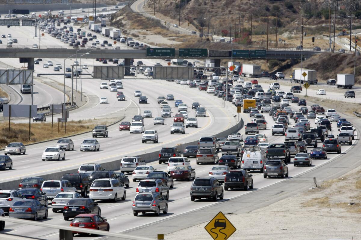 Heavy traffic slows the 5 Freeway northbound lanes at the 14 Freeway in August 2012. About 80% of travelers getting away for the Labor Day weekend will drive to their destination, according to the Auto Club of Southern California.