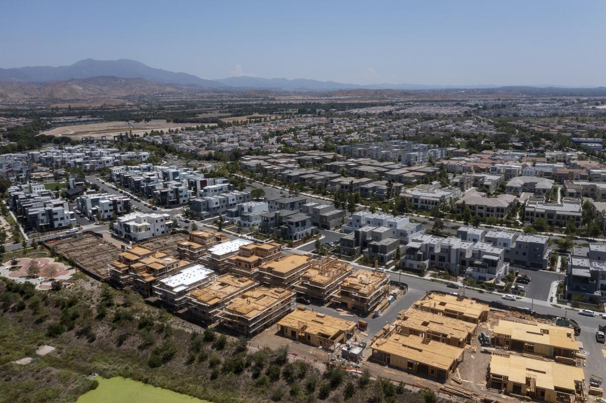 An aerial view of workers constructing new homes in Irvine in 2021.