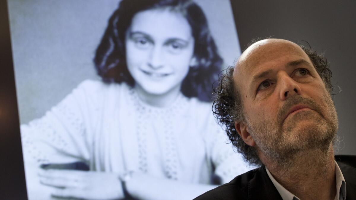 A picture of Anne Frank is projected as director Ronald Leopold of the Anne Frank Foundation listens during a press conference at the foundation's office in Amsterdam on Tuesday.