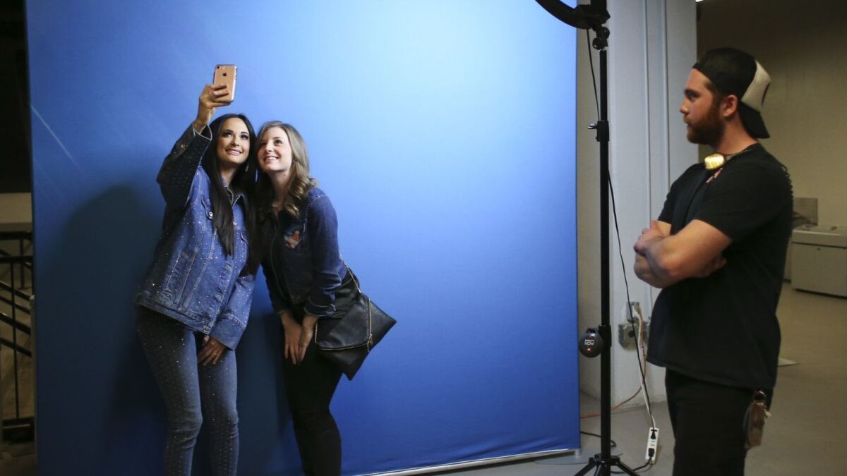 Kacey Musgraves takes a selfie with Ellen Bardsley of Cedar Rapids, Iowa, during a pre-show meet-and-greet.