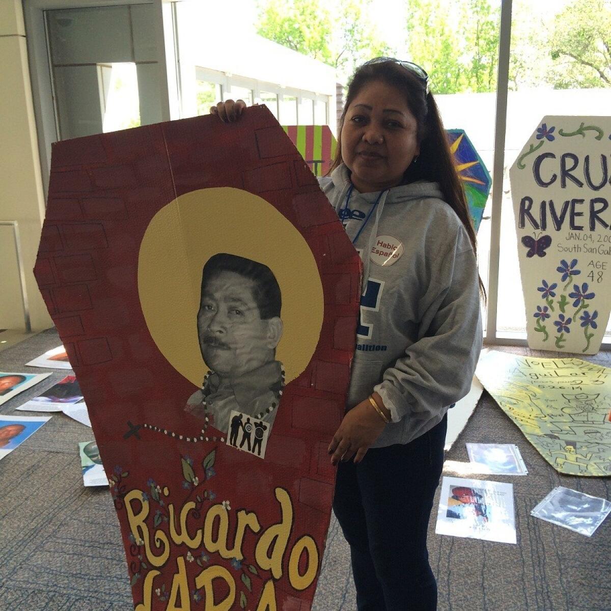 Los Angeles resident Albania Morales, with a coffin placard depicting the officer-involved death of her husband, Ricardo Lara, was among those who attended a crime victims rally in Sacramento seeking changes in state sentencing and policing laws.