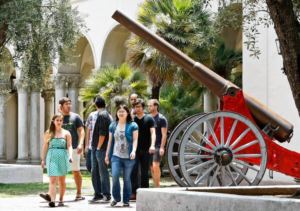 Students at Caltech walk past a cannon. In a tradition dating back to 1896, the cannon will be fired at the end of commencement ceremonies Friday.