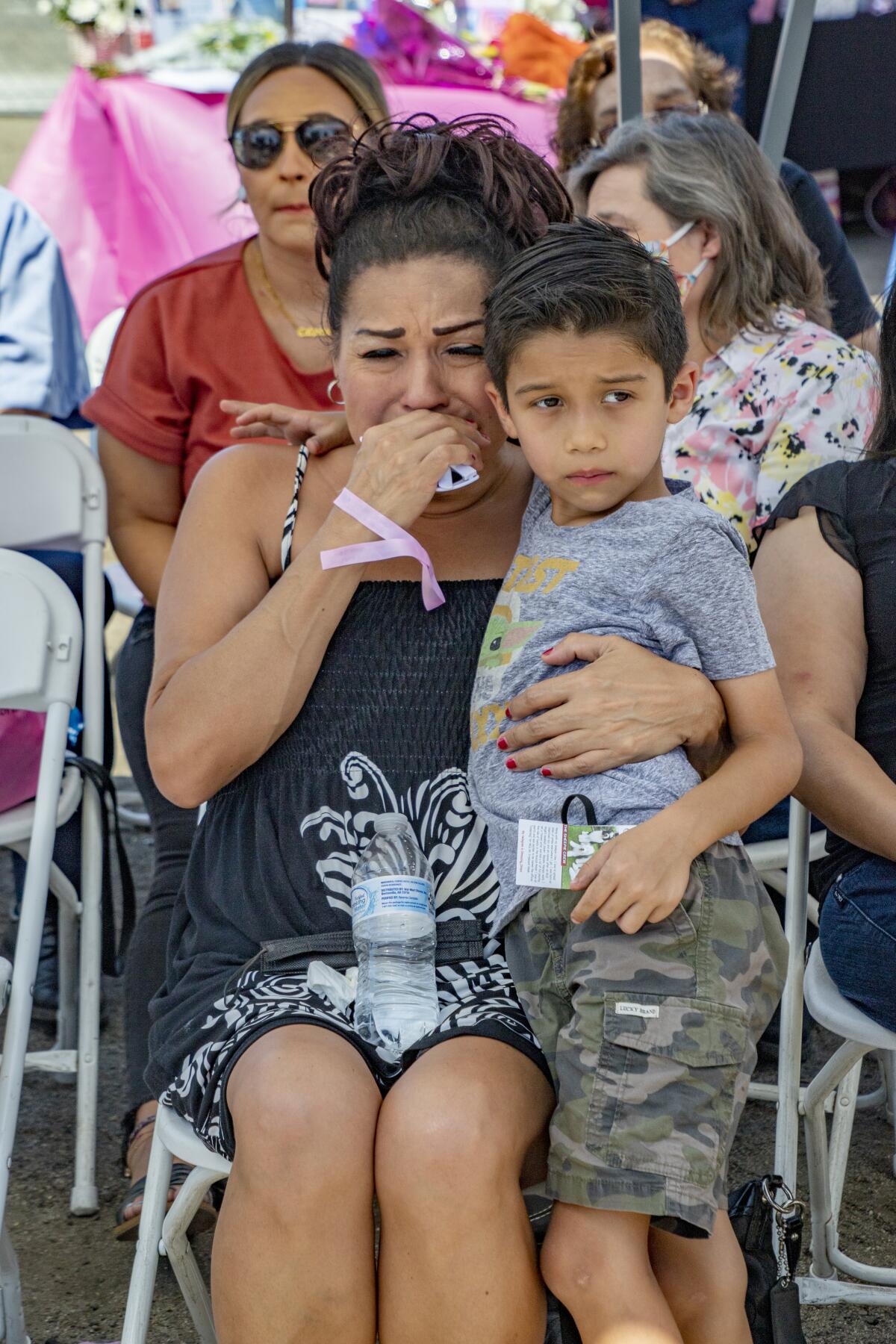 Great aunt Sara Nunez cries, with Victoria's cousin Nathan, as the Victoria Barrios mural is unveiled.