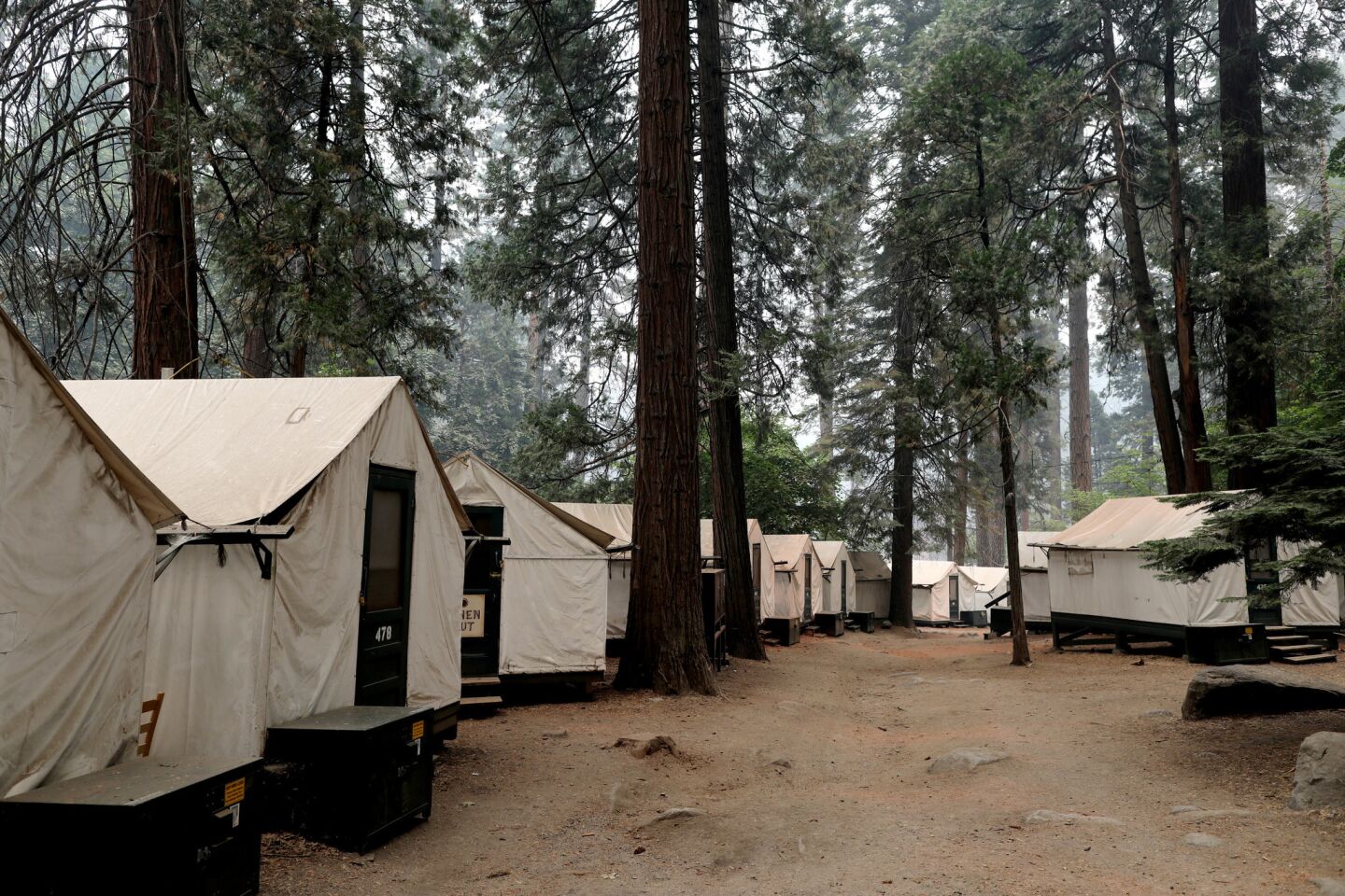 A deserted Half Dome Village in the Yosemite Valley remains clouded in smoke from the Ferguson fire.
