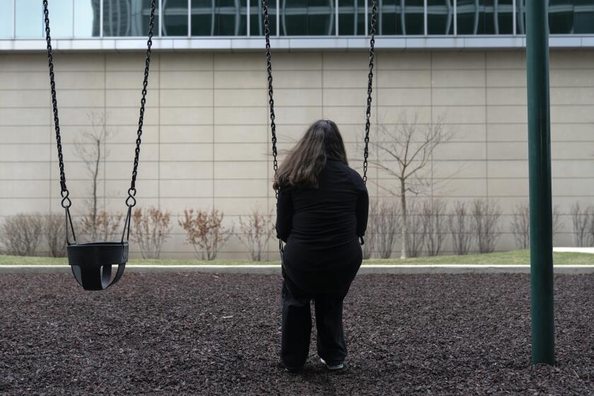 Amelia, 16, sits for a portrait in a park near her home in Illinois on Friday, March 24, 2023.