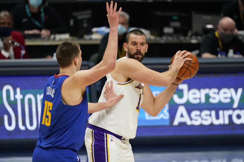Los Angeles Lakers center Marc Gasol (14) and Denver Nuggets center Nikola Jokic (15) in the second half of an NBA basketball game Sunday, Feb. 14, 2021, in Denver. (AP Photo/David Zalubowski)