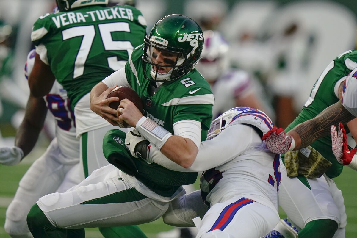 New York Jets quarterback Mike White, left, is sacked by Buffalo Bills' Efe Obada during the second half of an NFL football game, Sunday, Nov. 14, 2021, in East Rutherford, N.J. (AP Photo/Frank Franklin II)