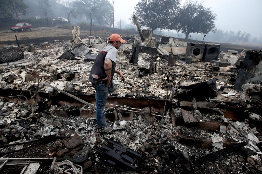 YREKA, CALIF. - AUG. 1 , 2022. James Benton looks at the remains of his home, which were destroyed by the McKinley fire as it burned along Highway 96 near Yreka over the weekend. The fire has charred about 51,000 acres and destroyed dozens of homes and structures. (Luis Sinco / Los Angeles Times)