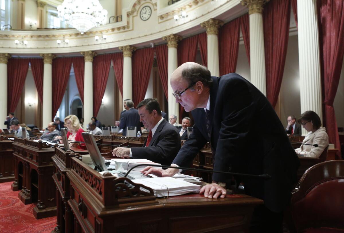 State Sen. Mark Wyland (R-Escondido) rises from his seat to check his computer screen as a bill is put up for a vote at the Capitol in Sacramento.