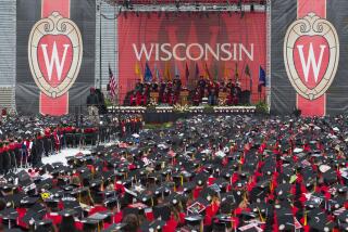 FILE - The commencement address is given during graduation at the University of Wisconsin in Madison, Wis., on May 12, 2018. The Universities of Wisconsin unveiled a $32 million workforce development plan Monday, Nov. 6, 2023 in an attempt to recover funds that were cut by the Republican-controlled Legislature earlier this year in a fight over campus diversity programs. (AP Photo/Jon Elswick, File)