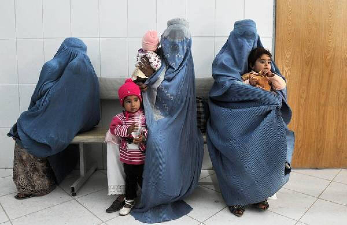 Afghan women wait in Herat to have their children vaccinated against polio. One volunteer vaccination worker was slain last weekend in Kapisa, north of Kabul, the Afghan capital.
