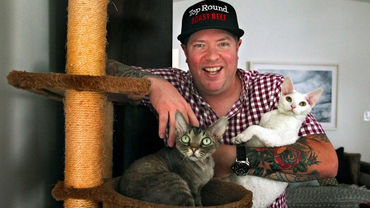 Chef Steven Fretz is photographed with his Devon Rex cats -- Lil Chef, left, and Delhlah -- at their home in Los Angeles.