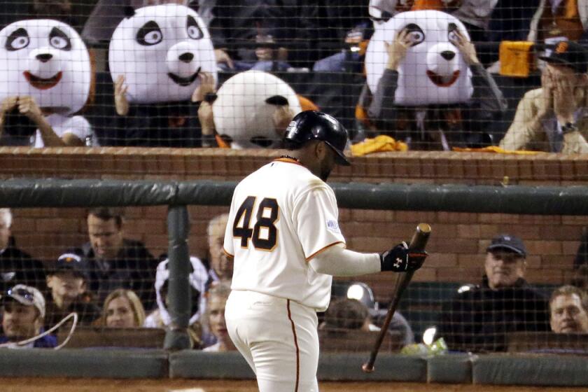 Giants fans wearing panda heads react after Pablo Sandoval, the "Kung Fu Panda," struck out in the third inning of Game 4 of the World Series.