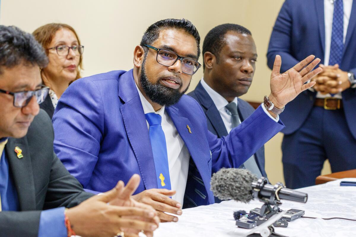 Guyanese President Mohamed Irfaan Ali gestures as he speaks during a news conference.