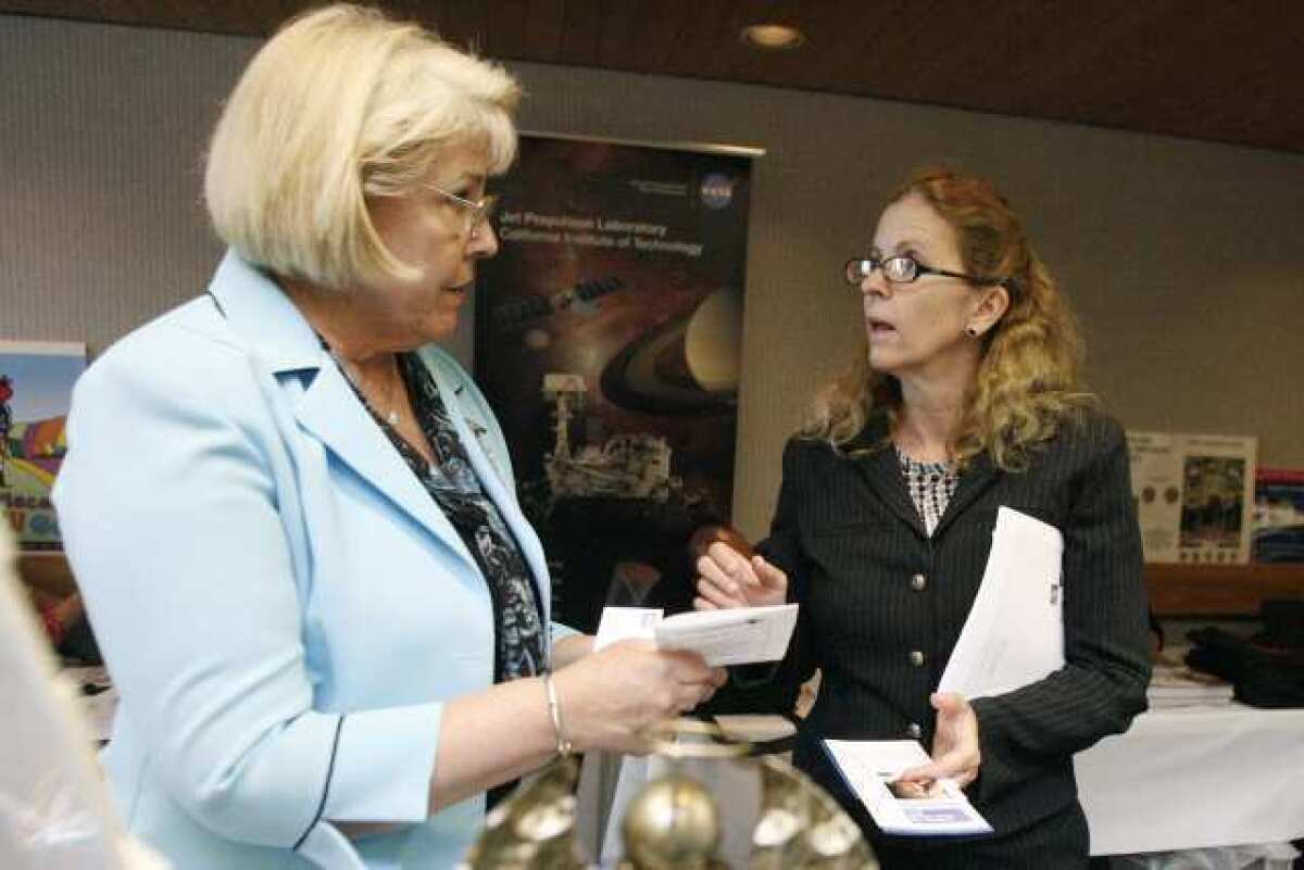 LIz Perrigue, from left, shares information about Angels Living Assistant Services to Lacey Middough during the Annual Foothills Community Business Expo, which took place at Verdugo Hills Hospital in La Canada.