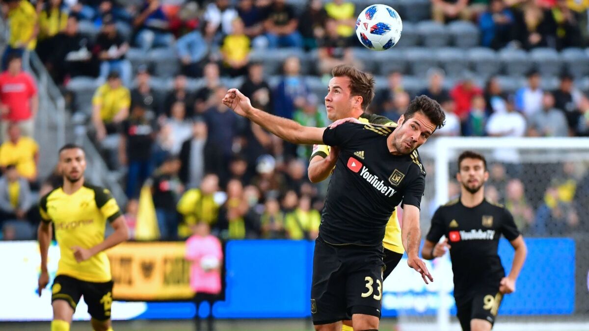 Borussia Dortmund's Mario Gotze, left, vies for the ball with LAFC's Julian Weigl during their international soccer friendly on Tuesday.