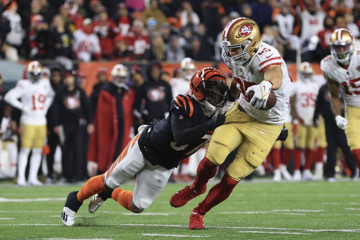 San Francisco 49ers' George Kittle (85) is tackled by Cincinnati Bengals' Ricardo Allen (37) during the second half of an NFL football game, Sunday, Dec. 12, 2021, in Cincinnati. (AP Photo/Aaron Doster)
