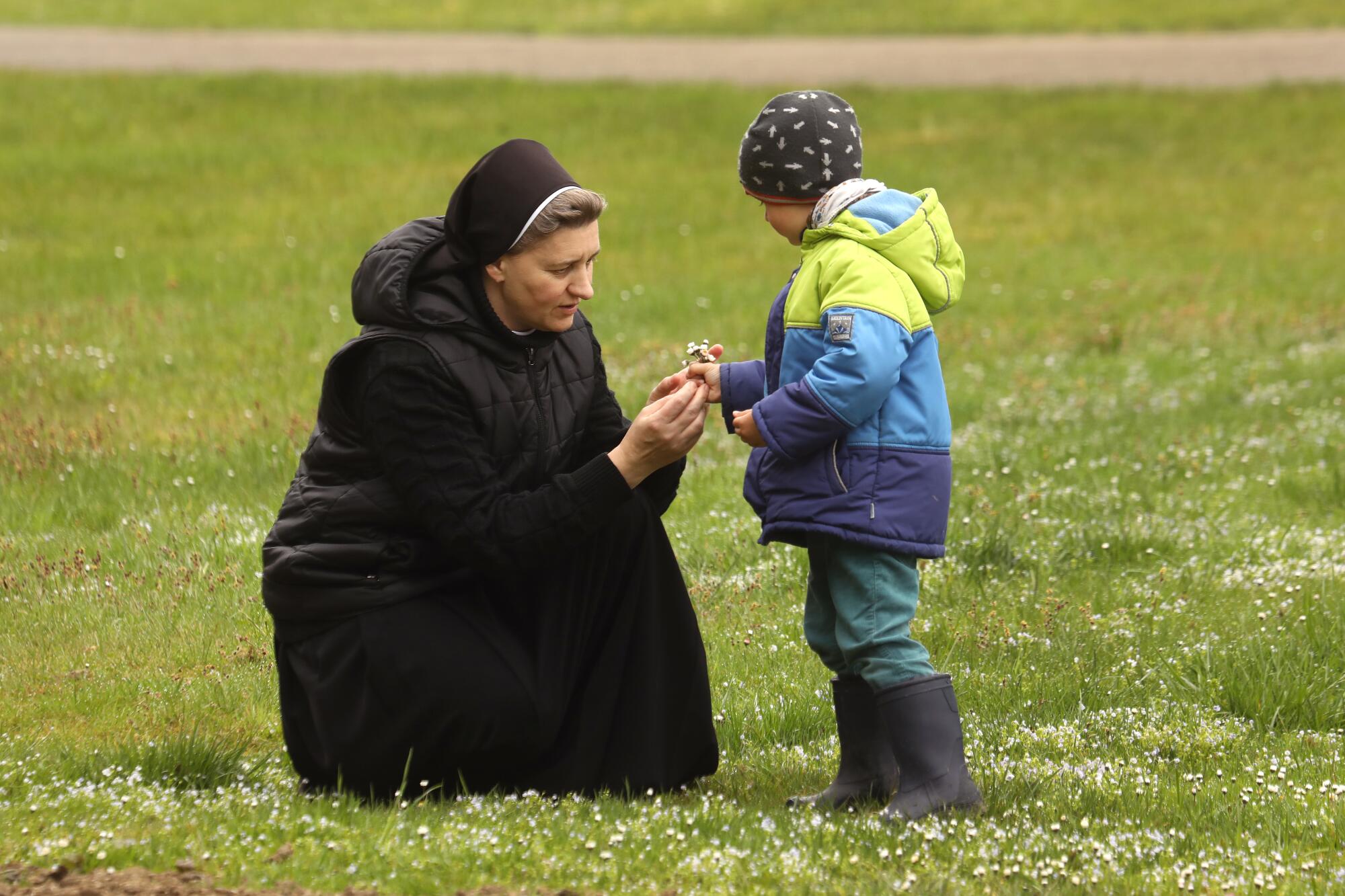 Sister Bernadette picks flowers with Ivan Mykhalo