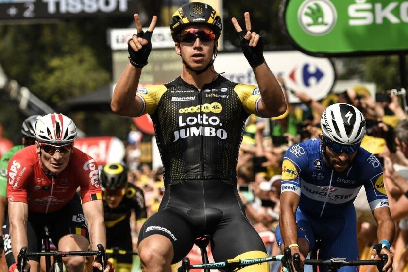 Netherlands' Dylan Groenewegen (C) celebrates as he crosses the finish line ahead of Germany's Andre Greipel (L) and Colombia's Fernando Gaviria to win the eighth stage of the 105th edition of the Tour de France cycling race between Dreux and Amiens, northern France, on July 14, 2018. / AFP PHOTO / Marco BERTORELLOMARCO BERTORELLO/AFP/Getty Images ** OUTS - ELSENT, FPG, CM - OUTS * NM, PH, VA if sourced by CT, LA or MoD **