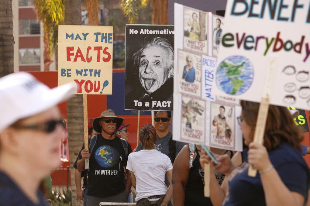 March for Science participants carry signs at Pershing Square.
