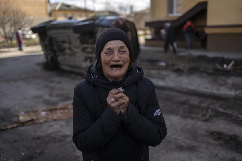 FILE - Tanya Nedashkivs'ka, 57, mourns the death of her husband who was killed in Bucha, on the outskirts of Kyiv, Ukraine, Monday, April 4, 2022. The United Nations human rights office says Russian forces carried out widespread and systematic torture of civilians who were detained in connection with its attack on Ukraine, and summarily executed dozens of them. (AP Photo/Rodrigo Abd, File)