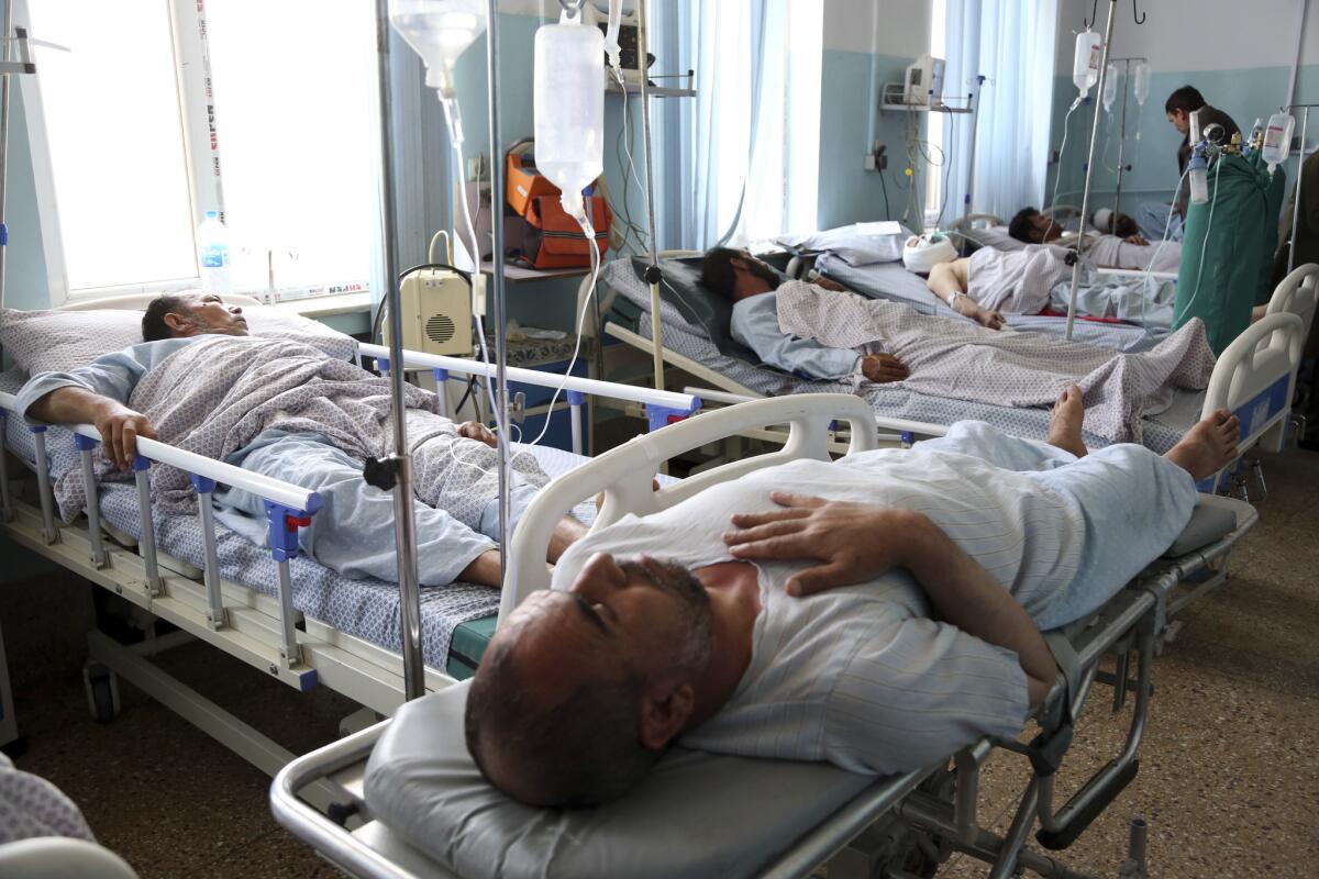 Wounded men receive treatment in a hospital after a bomb blast in Kabul, Afghanistan, on Monday.