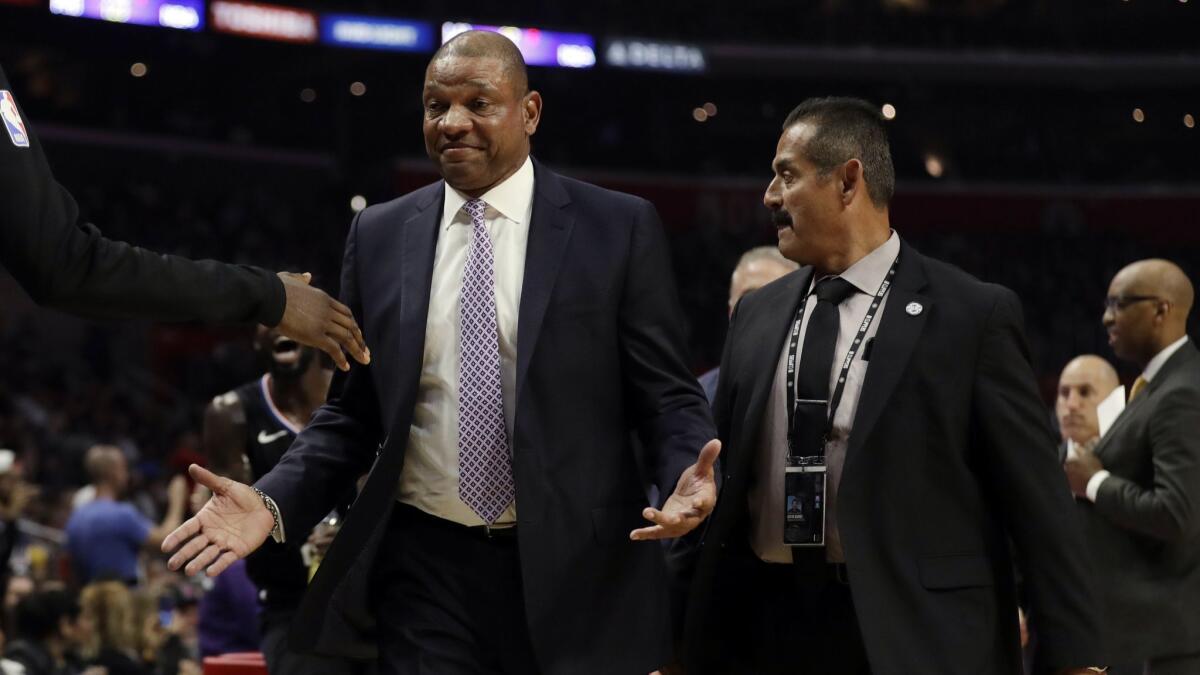 Clippers head coach Doc Rivers is escorted off the court after being ejected against the Chicago Bulls.