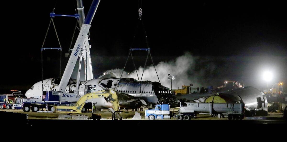Asiana Airlines Flight 214 is dismantled and hauled to a hangar at San Francisco International Airport. More than 180 people were hurt when the plane crash-landed, and three girls have died.
