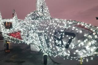 An F-9 Cougar is part of the new Jingle Jets holiday show at the USS Midway.