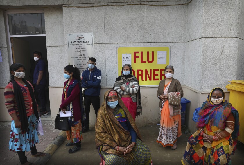 People wait outside a health center to get tested for COVID-19 in New Delhi, India, Thursday, Feb. 11, 2021. When the coronavirus pandemic took hold in India, there were fears it would sink the fragile health system of the world’s second-most populous country. Infections climbed dramatically for months and at one point India looked like it might overtake the United States as the country with the highest case toll. But infections began to plummet in September, and experts aren’t sure why. (AP Photo/Manish Swarup)